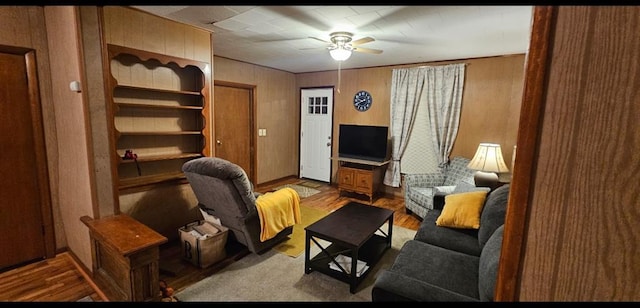 226 Mckenzie St, Barnard, MO 64423 - living room with ceiling fan, wood finished floors, and wooden walls