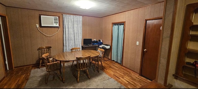 226 Mckenzie St, Barnard, MO 64423 - dining room featuring wood finished floors and an AC wall unit