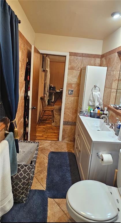 226 Mckenzie St, Barnard, MO 64423 - bathroom with tile walls, vanity, and tile patterned floors