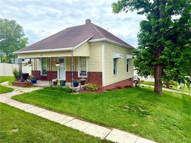 226 Mckenzie St, Barnard, MO 64423 - bungalow-style house with covered porch and brick siding