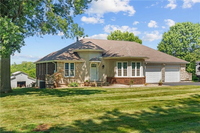3602 S Sweeney Rd, Grain Valley, MO 64029 - view of front of house with a garage, driveway, a front yard, and stucco siding