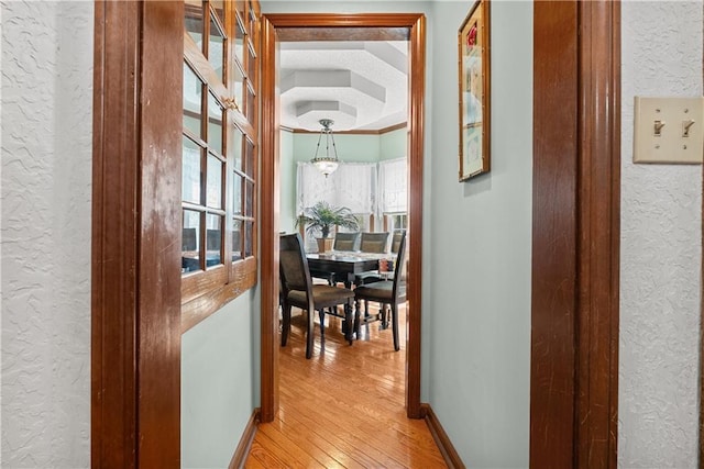 3602 S Sweeney Rd, Grain Valley, MO 64029 - corridor with a textured wall, light wood-style floors, and healthy amount of natural light