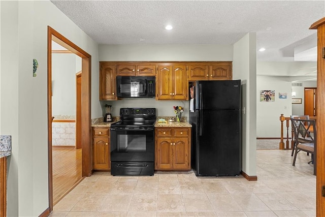 3602 S Sweeney Rd, Grain Valley, MO 64029 - kitchen featuring black appliances, brown cabinetry, a textured ceiling, light tile patterned flooring, and recessed lighting
