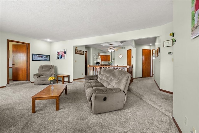 3602 S Sweeney Rd, Grain Valley, MO 64029 - carpeted living room featuring a textured ceiling and ceiling fan