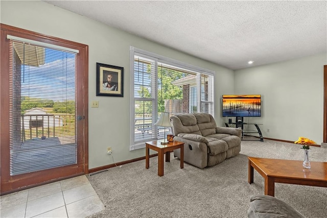3602 S Sweeney Rd, Grain Valley, MO 64029 - living area with a textured ceiling, light colored carpet, and light tile patterned floors