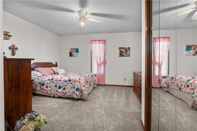 3602 S Sweeney Rd, Grain Valley, MO 64029 - carpeted bedroom featuring multiple windows, a textured ceiling, and a ceiling fan