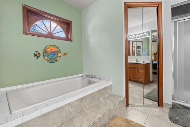 3602 S Sweeney Rd, Grain Valley, MO 64029 - bathroom with a garden tub, vanity, tile patterned floors, a textured ceiling, and an enclosed shower
