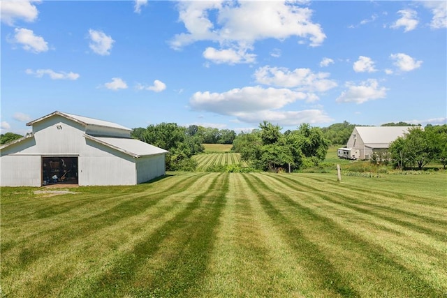 3602 S Sweeney Rd, Grain Valley, MO 64029 - view of grassy yard with a detached garage and an outdoor structure