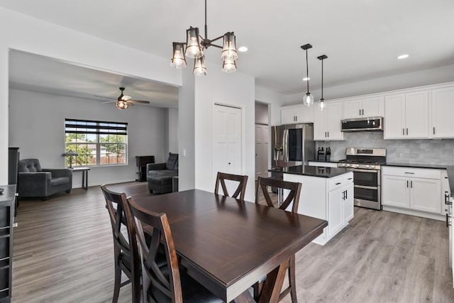 3102 Katy Trail Dr, Harrisonville, MO 64701 - dining room featuring ceiling fan, light wood finished floors, recessed lighting, and a chandelier