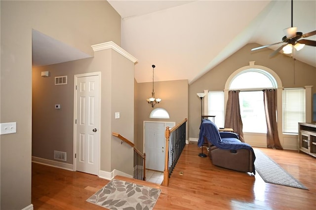 19617 Harbor Dr, Smithville, MO 64089 - foyer featuring high vaulted ceiling, a ceiling fan, wood finished floors, and a chandelier