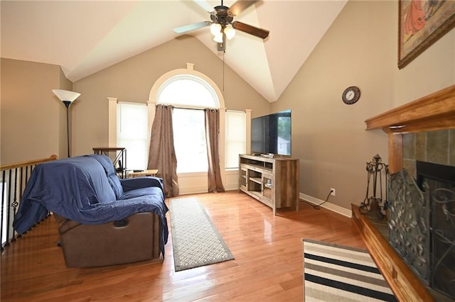 19617 Harbor Dr, Smithville, MO 64089 - living area featuring ceiling fan, a fireplace, vaulted ceiling, and light wood-style flooring