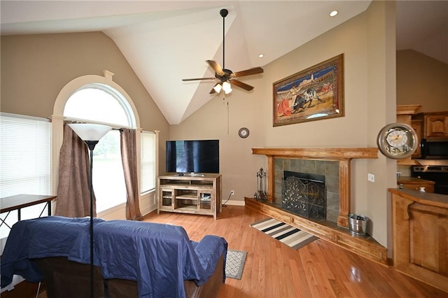 19617 Harbor Dr, Smithville, MO 64089 - living room with a fireplace, ceiling fan, wood finished floors, and high vaulted ceiling