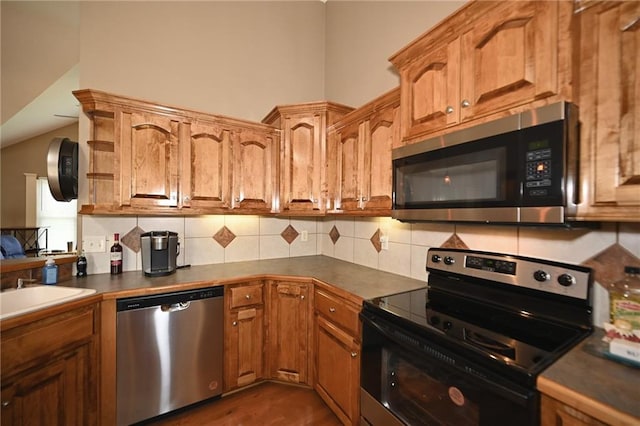 19617 Harbor Dr, Smithville, MO 64089 - kitchen featuring appliances with stainless steel finishes, dark countertops, and decorative backsplash