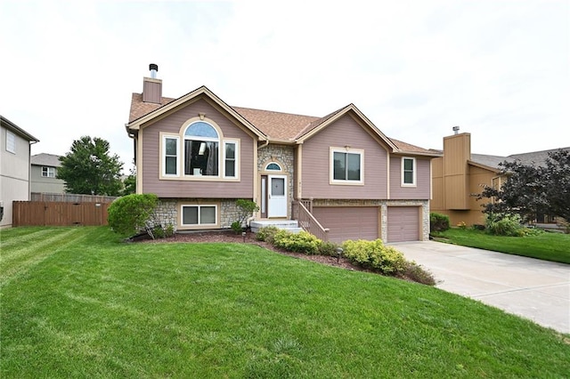 19617 Harbor Dr, Smithville, MO 64089 - bi-level home featuring a chimney, a garage, concrete driveway, and stone siding
