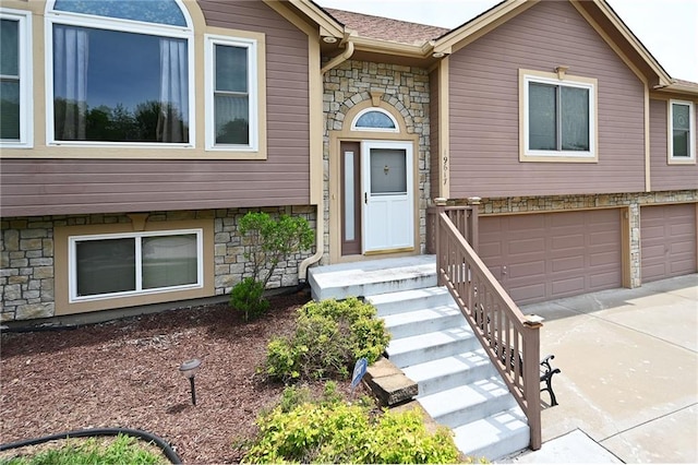 19617 Harbor Dr, Smithville, MO 64089 - view of front of house with stone siding, concrete driveway, and a garage