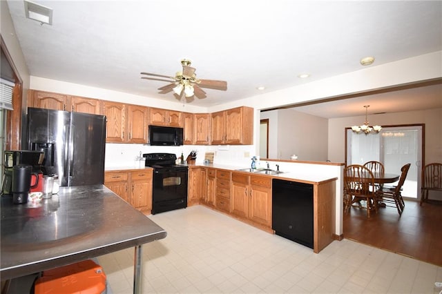 211 Southside Ct, Excelsior Springs, MO 64024 - kitchen featuring black appliances, a ceiling fan, a peninsula, a chandelier, and brown cabinetry
