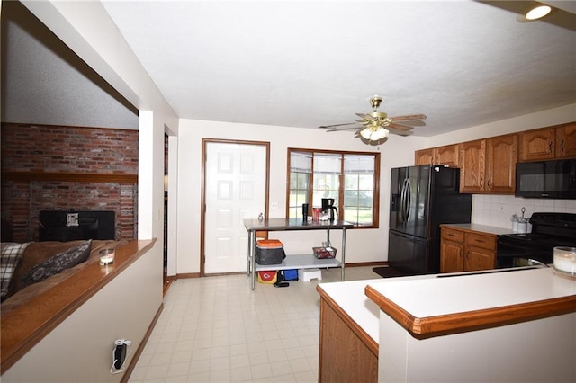 211 Southside Ct, Excelsior Springs, MO 64024 - kitchen featuring black appliances, brown cabinets, ceiling fan, light flooring, and decorative backsplash