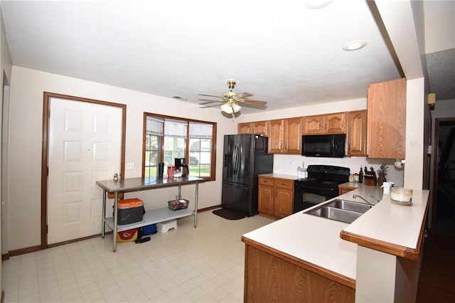 211 Southside Ct, Excelsior Springs, MO 64024 - kitchen featuring black appliances, brown cabinets, a ceiling fan, light floors, and light countertops