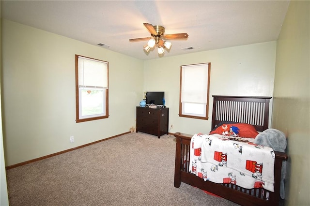 211 Southside Ct, Excelsior Springs, MO 64024 - carpeted bedroom featuring baseboards and a ceiling fan