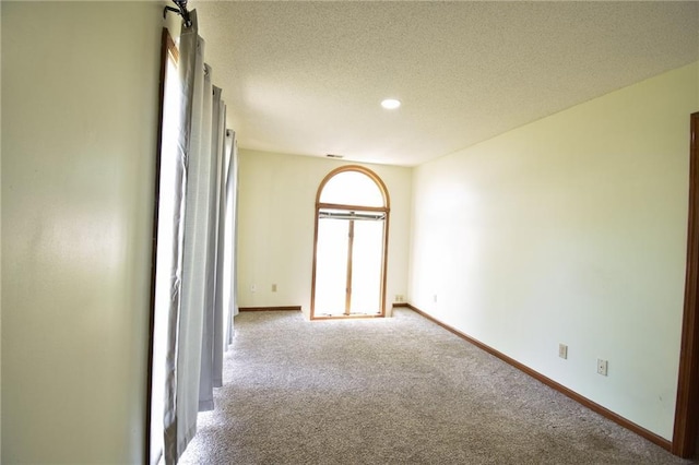 211 Southside Ct, Excelsior Springs, MO 64024 - carpeted spare room with a textured ceiling and recessed lighting
