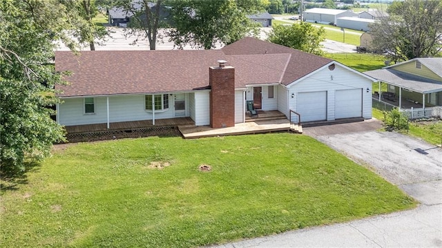 211 Southside Ct, Excelsior Springs, MO 64024 - ranch-style home featuring asphalt driveway, an attached garage, a front yard, and a chimney