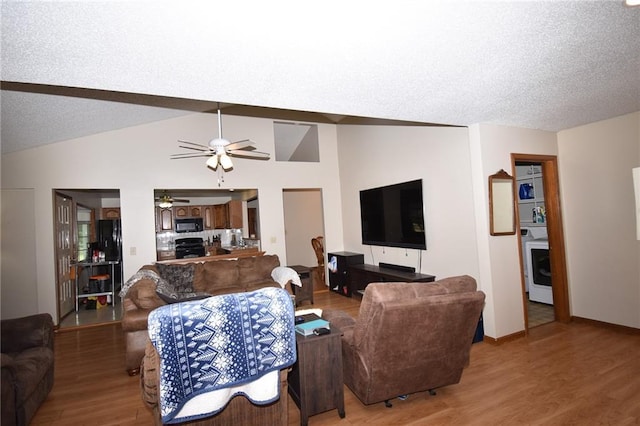 211 Southside Ct, Excelsior Springs, MO 64024 - living area featuring ceiling fan, wood finished floors, vaulted ceiling, a textured ceiling, and washer / dryer