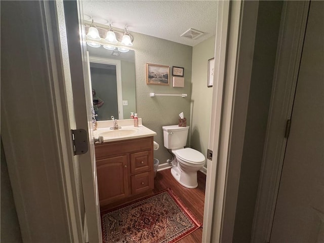 21086 Millridge St, Spring Hill, KS 66083 - half bathroom with wood finished floors, a textured ceiling, vanity, and a textured wall