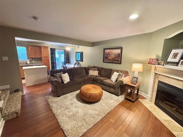 21086 Millridge St, Spring Hill, KS 66083 - living room featuring dark wood finished floors, a tile fireplace, and recessed lighting