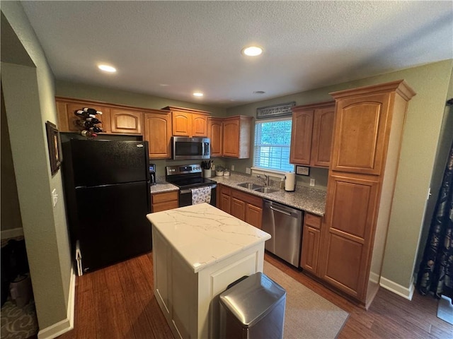21086 Millridge St, Spring Hill, KS 66083 - kitchen with black appliances, dark wood-style floors, a center island, brown cabinetry, and light stone countertops