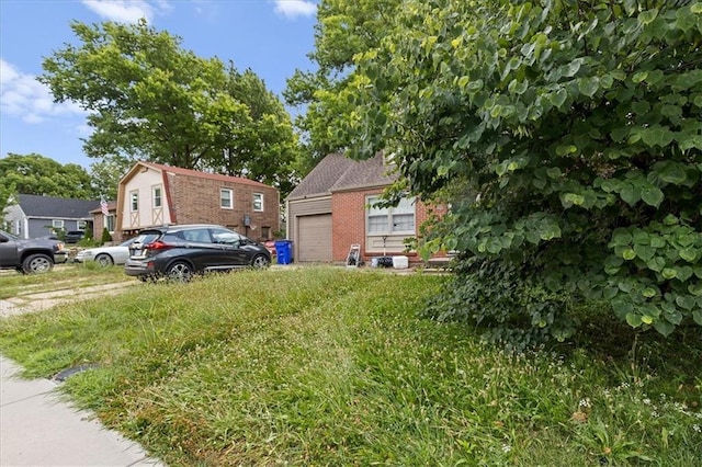 900 S Hunter Dr, Olathe, KS 66061 - view of side of home featuring a garage and brick siding