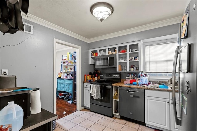 900 S Hunter Dr, Olathe, KS 66061 - kitchen featuring appliances with stainless steel finishes, light tile patterned flooring, crown molding, white cabinets, and open shelves
