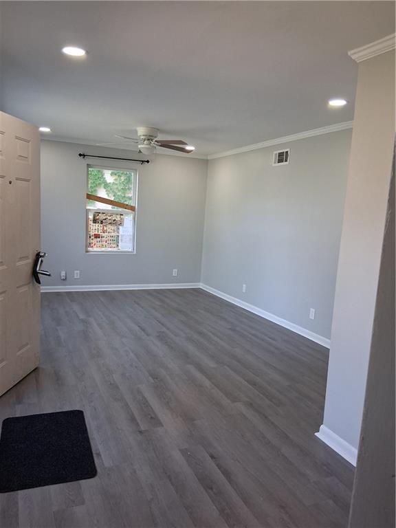3304 Norton St, Kansas City, MO 64128 - spare room with crown molding, a ceiling fan, dark wood finished floors, and recessed lighting