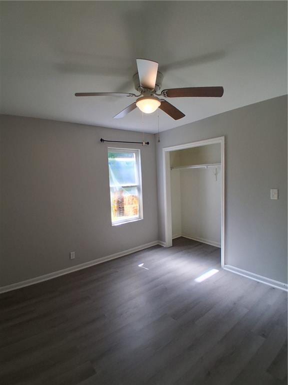 3304 Norton St, Kansas City, MO 64128 - unfurnished bedroom featuring dark wood-style floors, a closet, and a ceiling fan