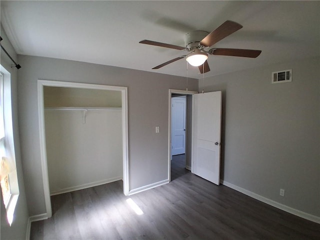 3304 Norton St, Kansas City, MO 64128 - unfurnished bedroom featuring dark wood finished floors, a closet, and a ceiling fan