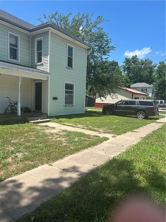 209 S Prairie, Yates Center, KS 66783 - view of home's exterior with a yard