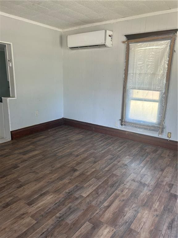 209 S Prairie, Yates Center, KS 66783 - empty room with an AC wall unit, dark wood finished floors, and crown molding