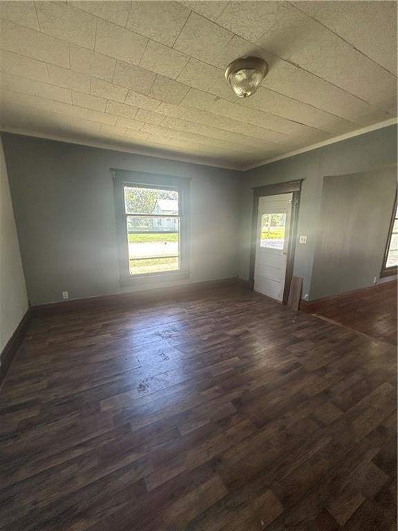 209 S Prairie, Yates Center, KS 66783 - unfurnished room featuring dark wood-style floors and ornamental molding