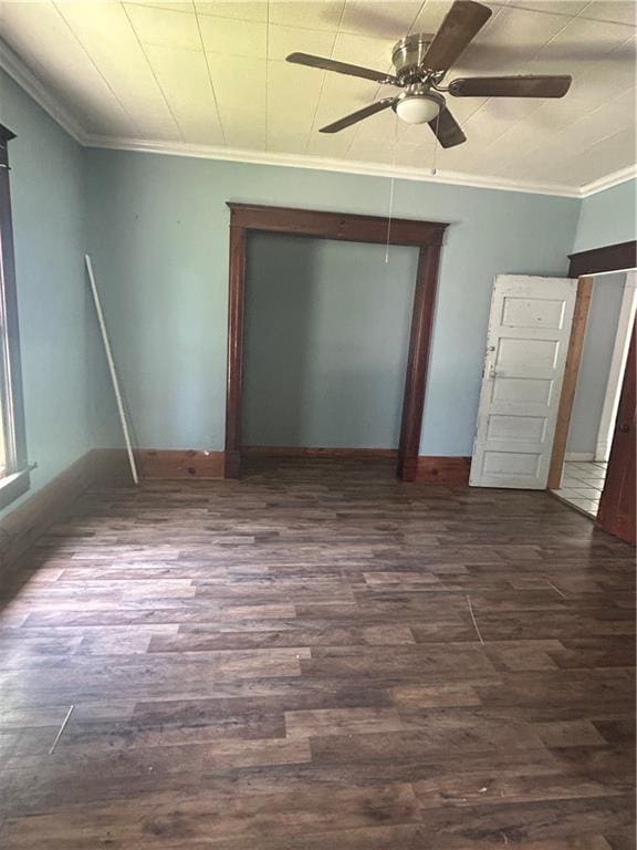209 S Prairie, Yates Center, KS 66783 - spare room featuring a ceiling fan, dark wood-style flooring, and ornamental molding