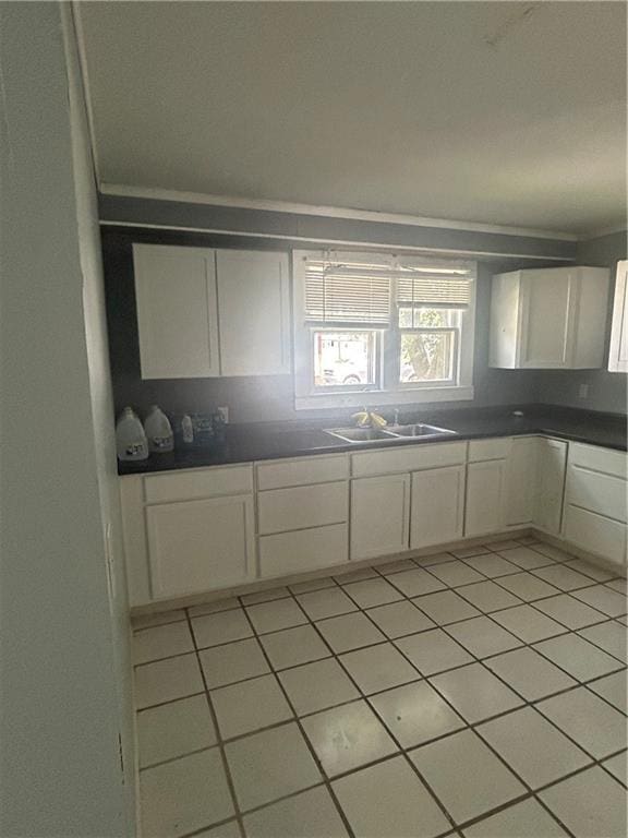 209 S Prairie, Yates Center, KS 66783 - kitchen featuring white cabinets, dark countertops, and light tile patterned flooring