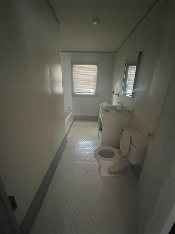 209 S Prairie, Yates Center, KS 66783 - bathroom featuring toilet and baseboards