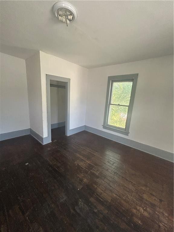 209 S Prairie, Yates Center, KS 66783 - spare room featuring dark wood-type flooring