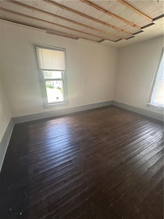 209 S Prairie, Yates Center, KS 66783 - spare room featuring healthy amount of natural light and dark wood finished floors