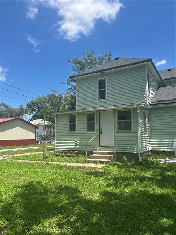 209 S Prairie, Yates Center, KS 66783 - rear view of property featuring entry steps and a lawn
