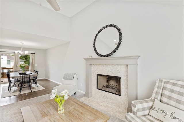 20335 W 220th Ter, Spring Hill, KS 66083 - living room featuring a chandelier, wood finished floors, a tile fireplace, and a ceiling fan