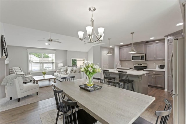 20335 W 220th Ter, Spring Hill, KS 66083 - dining area with a ceiling fan, dark wood-style flooring, recessed lighting, and a chandelier