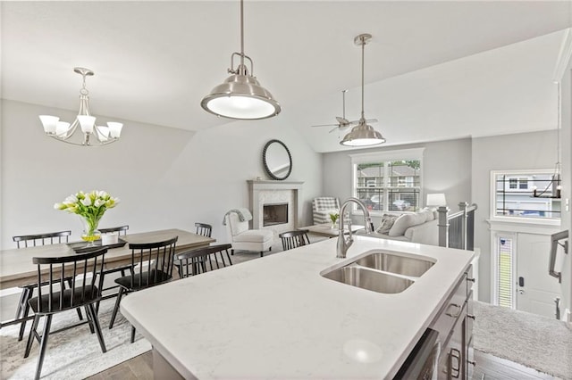 20335 W 220th Ter, Spring Hill, KS 66083 - kitchen with a fireplace, dark wood-style floors, a chandelier, a center island with sink, and stainless steel dishwasher