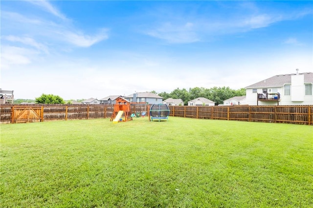 20335 W 220th Ter, Spring Hill, KS 66083 - fenced backyard with a playground, a trampoline, and a residential view