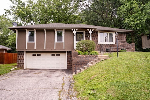 2421 Elephant Trl, Saint Joseph, MO 64506 - view of front facade with asphalt driveway, a garage, and brick siding