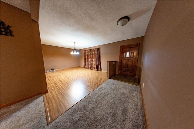 2421 Elephant Trl, Saint Joseph, MO 64506 - carpeted entryway featuring a chandelier, a textured ceiling, and wood finished floors