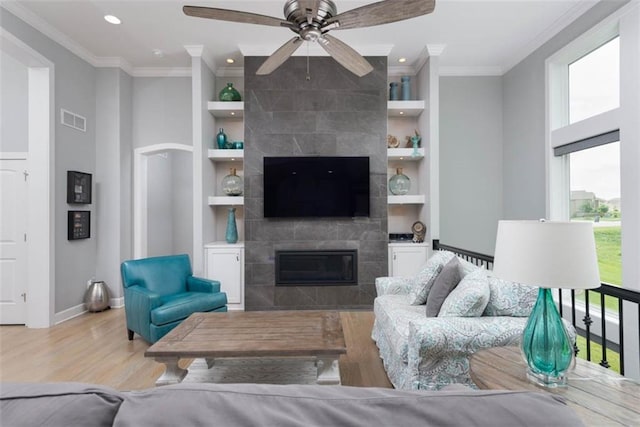 14423 N 145th St, Basehor, KS 66007 - living room featuring built in shelves, wood finished floors, ceiling fan, recessed lighting, and crown molding